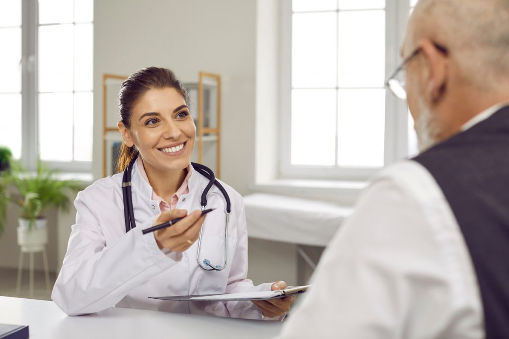 Smiling woman doctor consult old male patient | Pension de reversion femme médecin avec patient