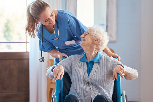 Nurse, home and elderly woman with a disability in a wheelchair in medical nursing facility. Happy, healthcare and doctor helping and talking to disabled senior lady in retirement house in Australia. | Pension de reversion