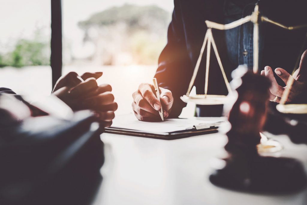 Business woman and lawyers discussing contract papers with brass | Pension de reversion protection juridique seniors