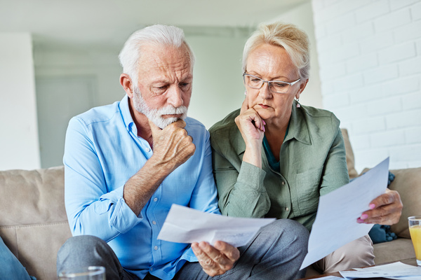 woman man senior bill finance retirement couple home document calculator paper wife budget elderly together mature old retired paperwork tax | Pension de reversion revalorisation retraite complementaire