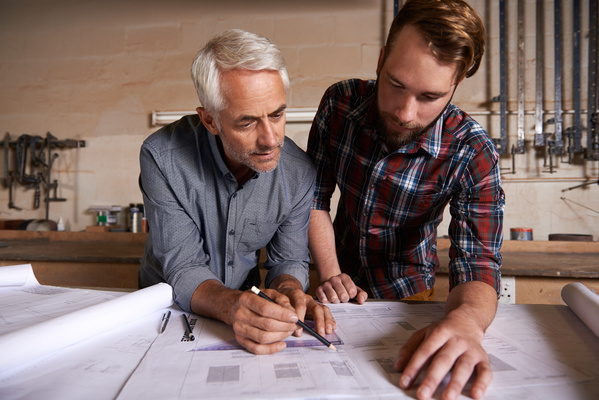 Architect team working on blueprint in workshop and designer for engineering collaboration Senior in architecture with male trainee work on remodeling project with floor plan paperwork and drawing | Pension de reversion toucher deux pensions de retraite