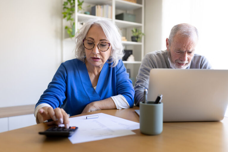 Couple de seniors calculant l'impact de la retraite à 67,6 ans sur leur budget