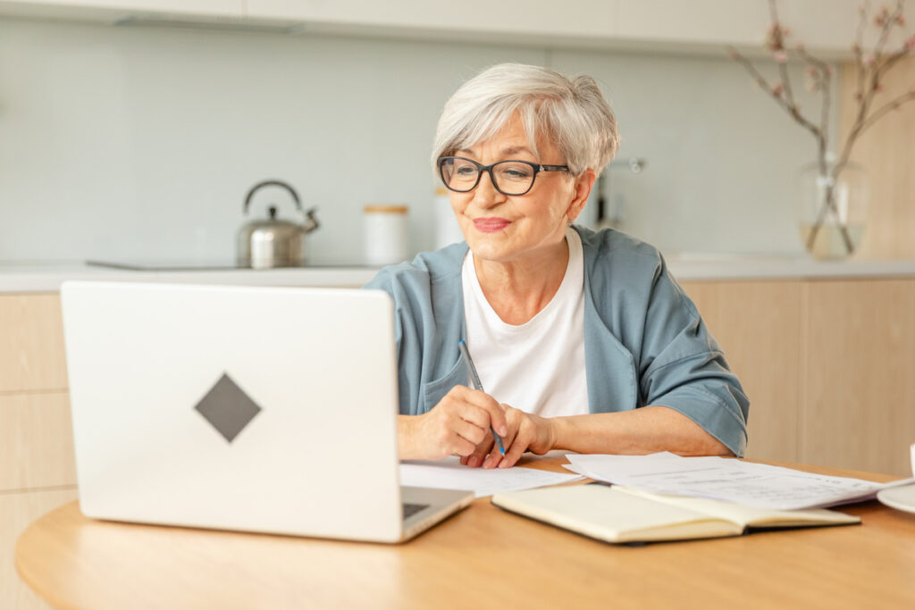 Demande de pension réversion pour une carrière européenne | Pension de reversion Femme âgée préparant les documents pour sa pension réversion pour une carrière européenne